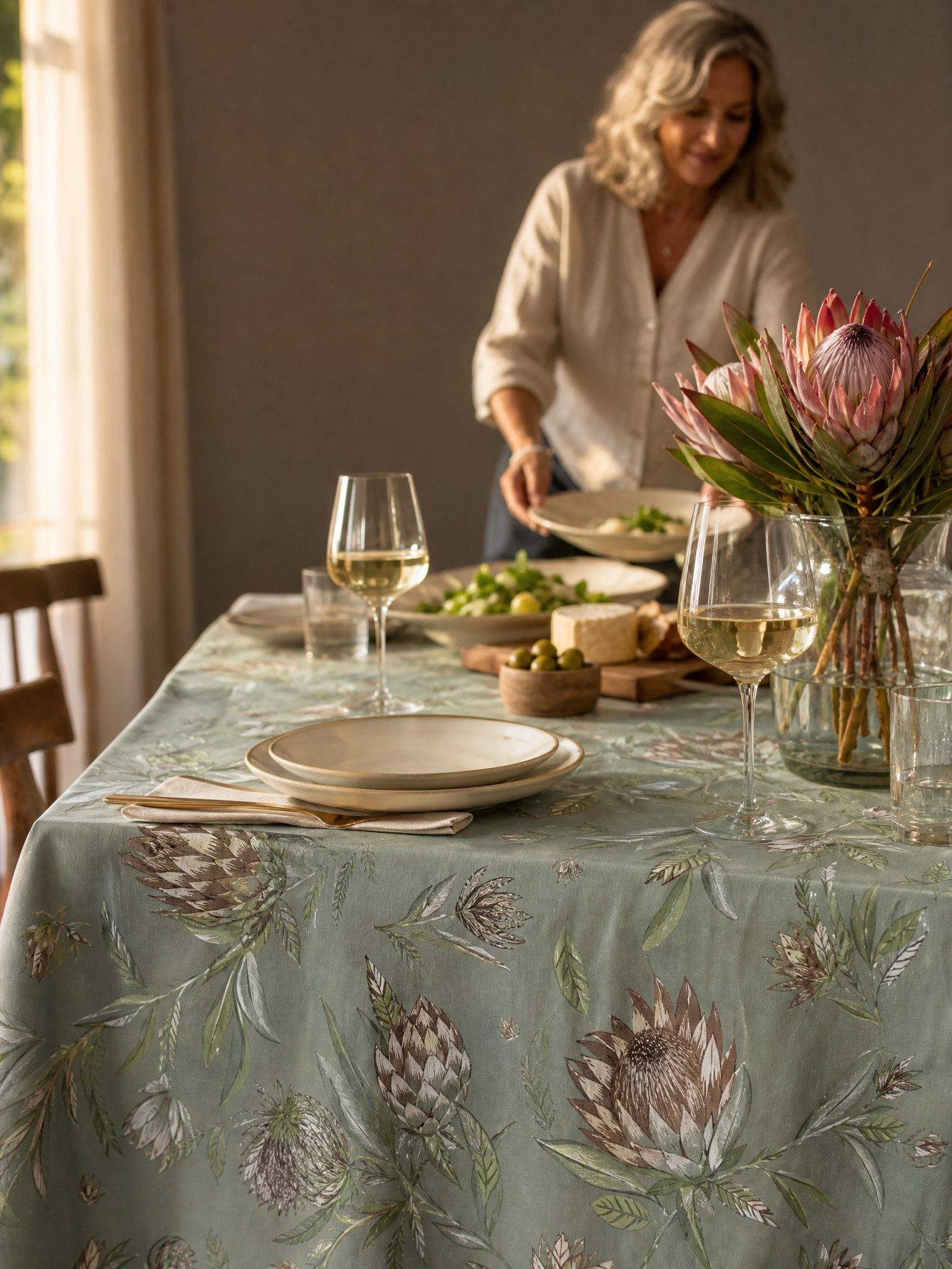 A South African family table set with a protea tablecloth at golden hour