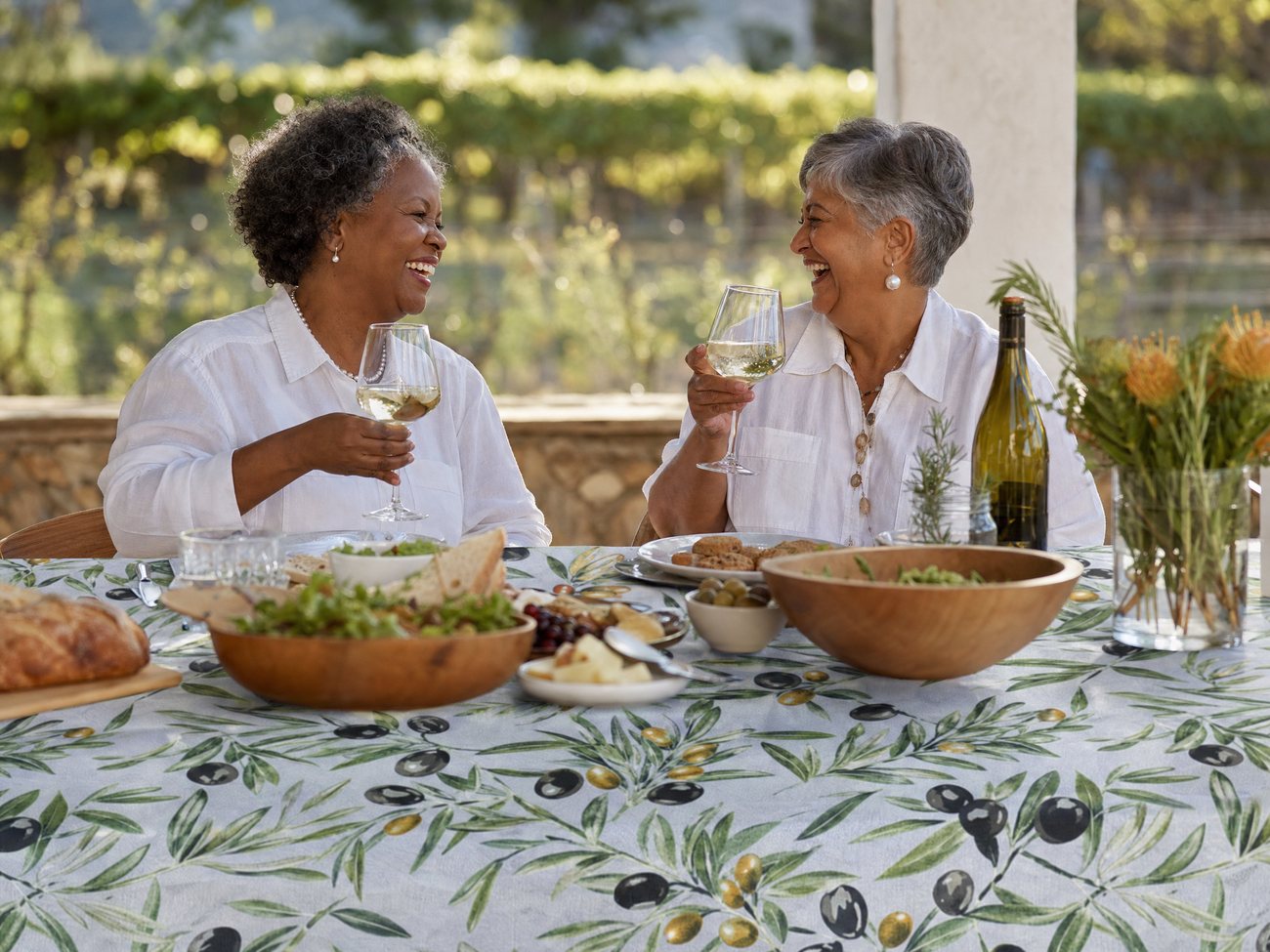 Two women sharing wine at a beautifully set table